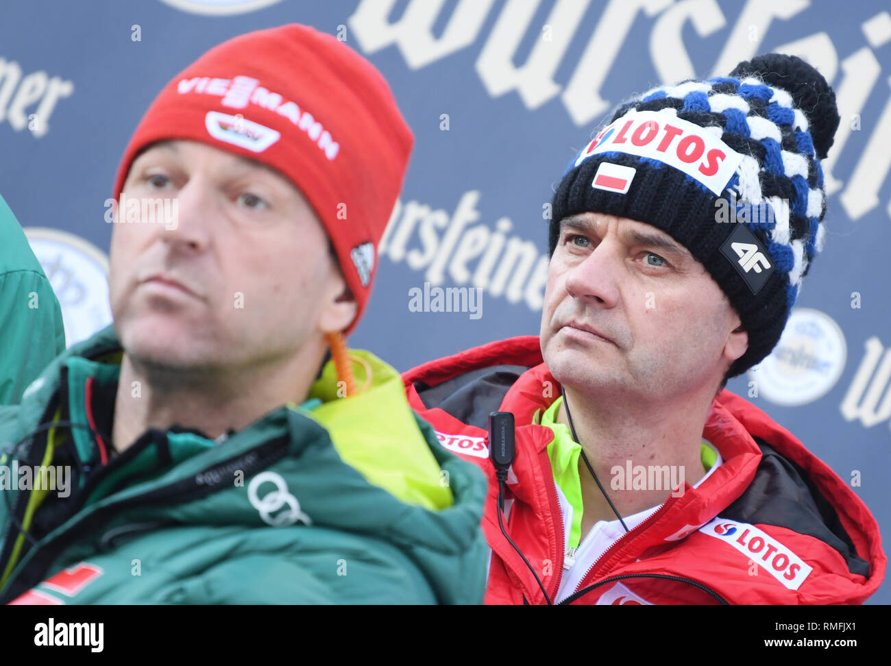 Willingen, Germany. 15th Feb, 2019. Nordic skiing, ski jumping, World Cup, team jumping: National coach Werner Schuster (l) is standing on the coaching stand next to the Polish head coach Stefan Horngacher. Credit: Arne Dedert/dpa/Alamy Live News Stock Photo