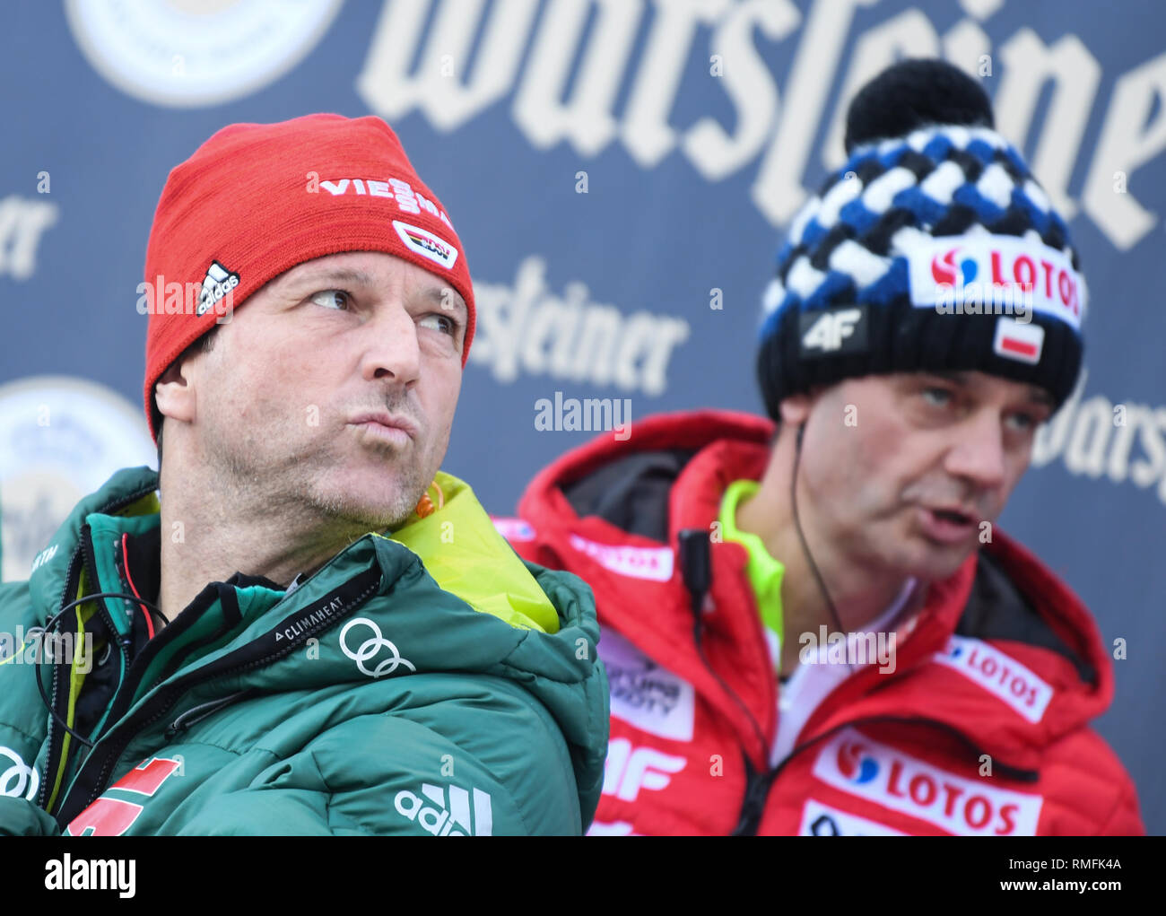 15 February 2019, Hessen, Willingen: Nordic skiing, ski jumping, World Cup, team jumping: National coach Werner Schuster (l) is standing on the coaching stand next to the Polish head coach Stefan Horngacher. Photo: Arne Dedert/dpa Stock Photo