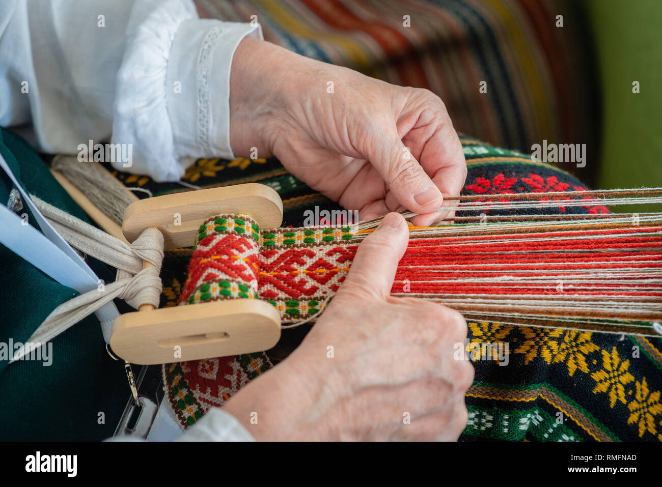 Woman working at the weaving loom. Traditional Ethnic craft of Baltic