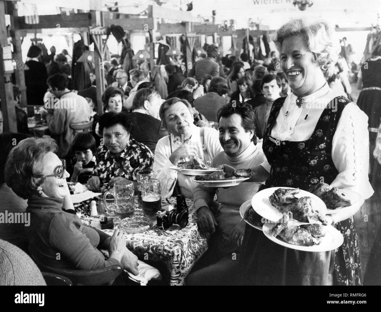 A waitress serves roast chicken at the Oktoberfest (undated photo). Stock Photo