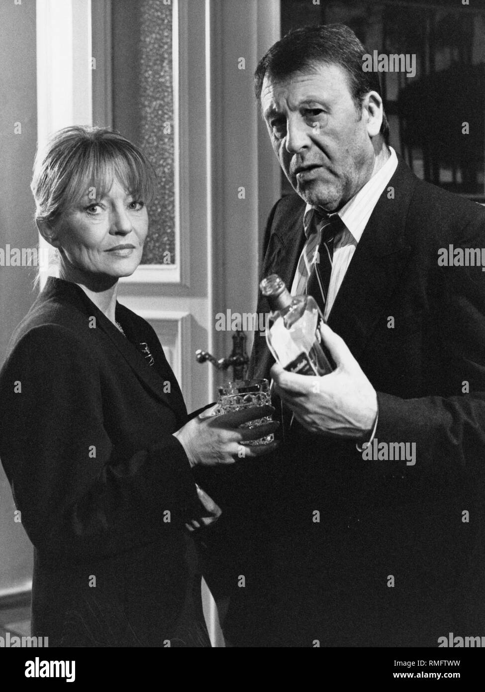 Guenter Lamprecht (right) as commissioner in the TV crime series Tatort, here together with Karin Ball in the CRC crime scene 'Frolic at five'. Stock Photo