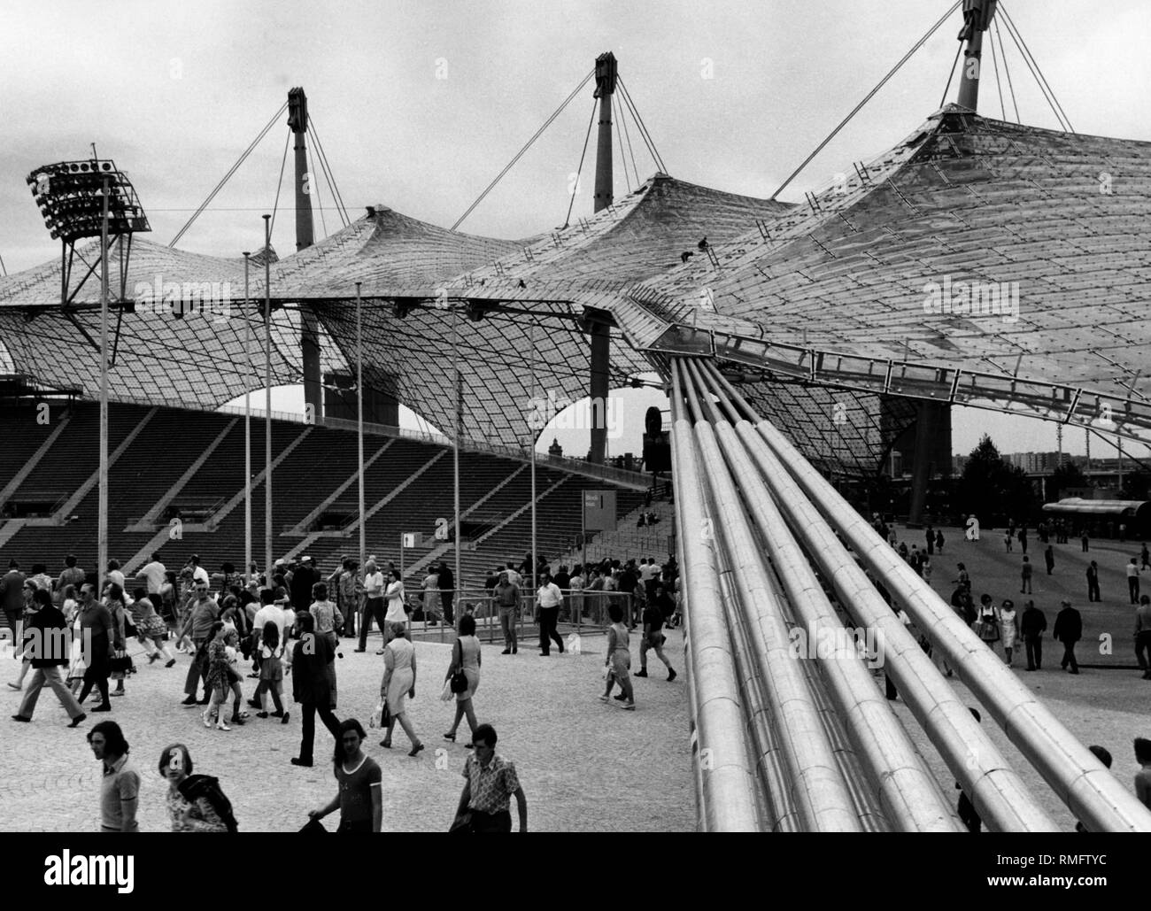 Visitors at the Munich Olympic Stadium look at the grandstand, at right, the north curve. Stock Photo