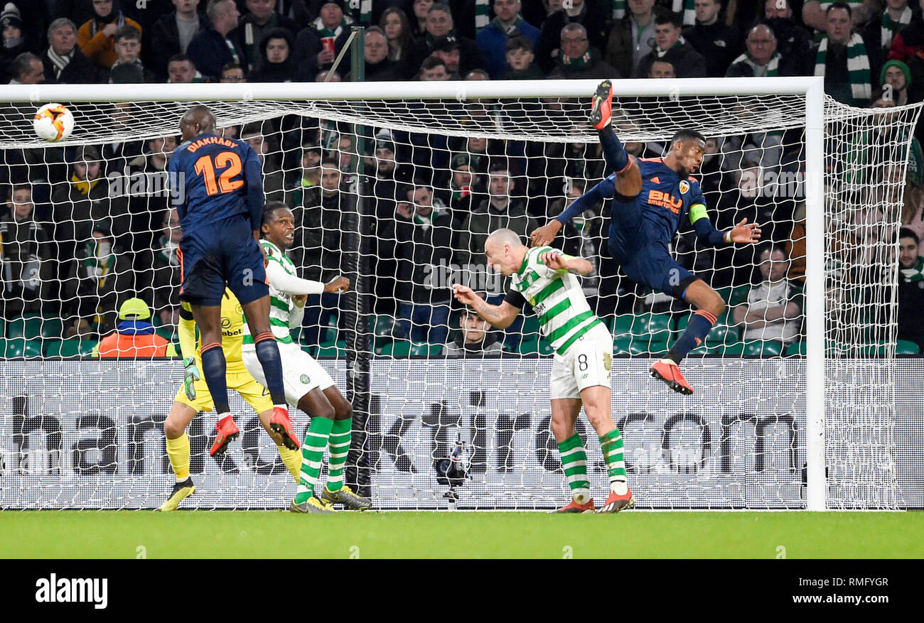 Valencia's Geoffrey Kondogbia and Mouctar Diakhaby try to get on the end of a cross as they are challenged by Celtic Dedryck Boyata and Scott Brown during the UEFA Europa League round of 32, first leg match at Celtic Park, Glasgow. Stock Photo