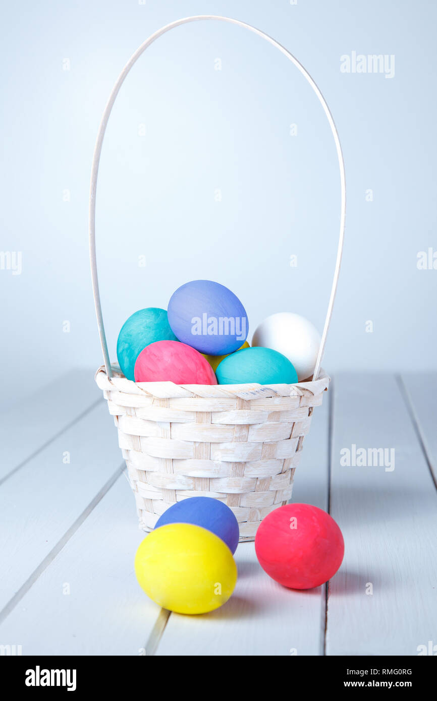 Easter eggs in the basket on wooden boards on a white background Stock ...