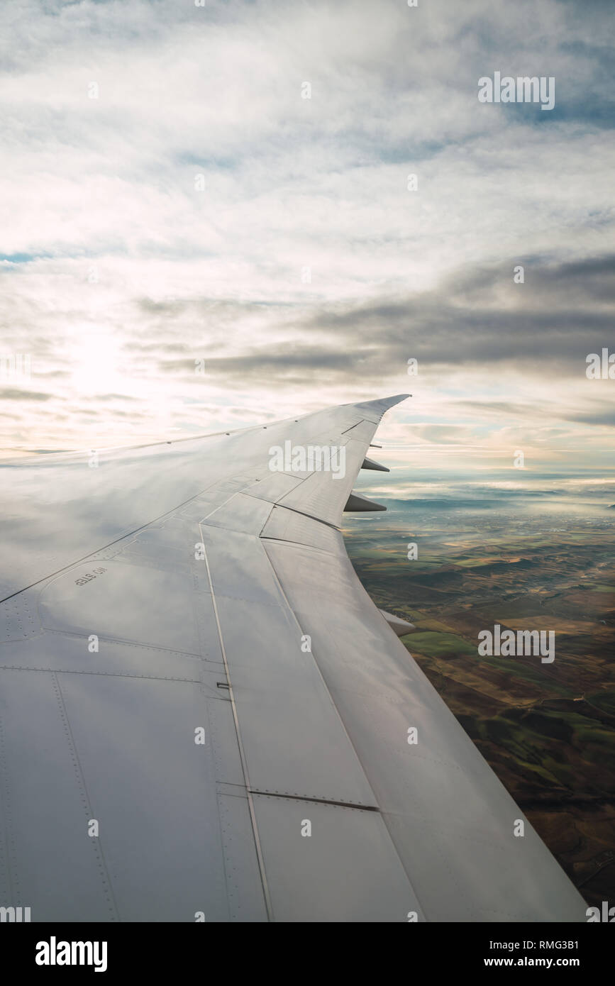 Bearded passenger using device in aircraft Stock Photo