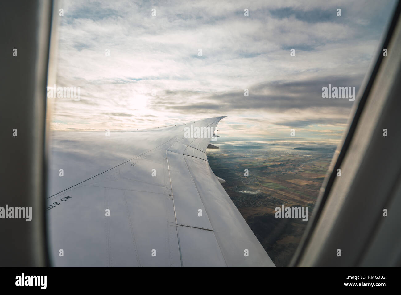 Bearded passenger using device in aircraft Stock Photo