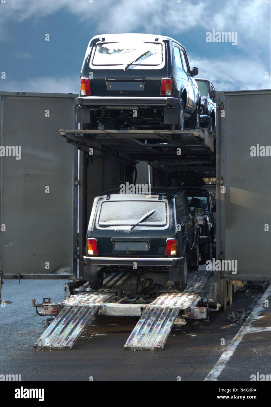 Two-level auto train with new cars for unloading in summer day Stock Photo
