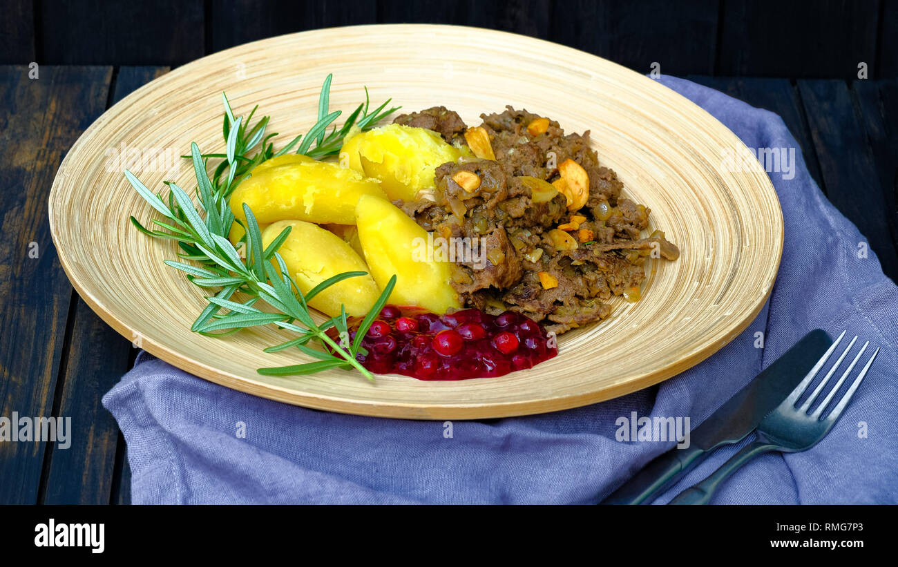 Sauteed reindeer, sweet Yellow Finn potatoes and lingonberry jam. A typical Lapland food in Finland and Sweden. Tourists also love this comfort food Stock Photo