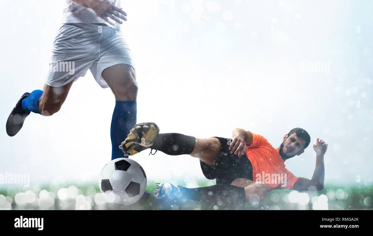 Close up of a football action scene with competing soccer players on white background Stock Photo
