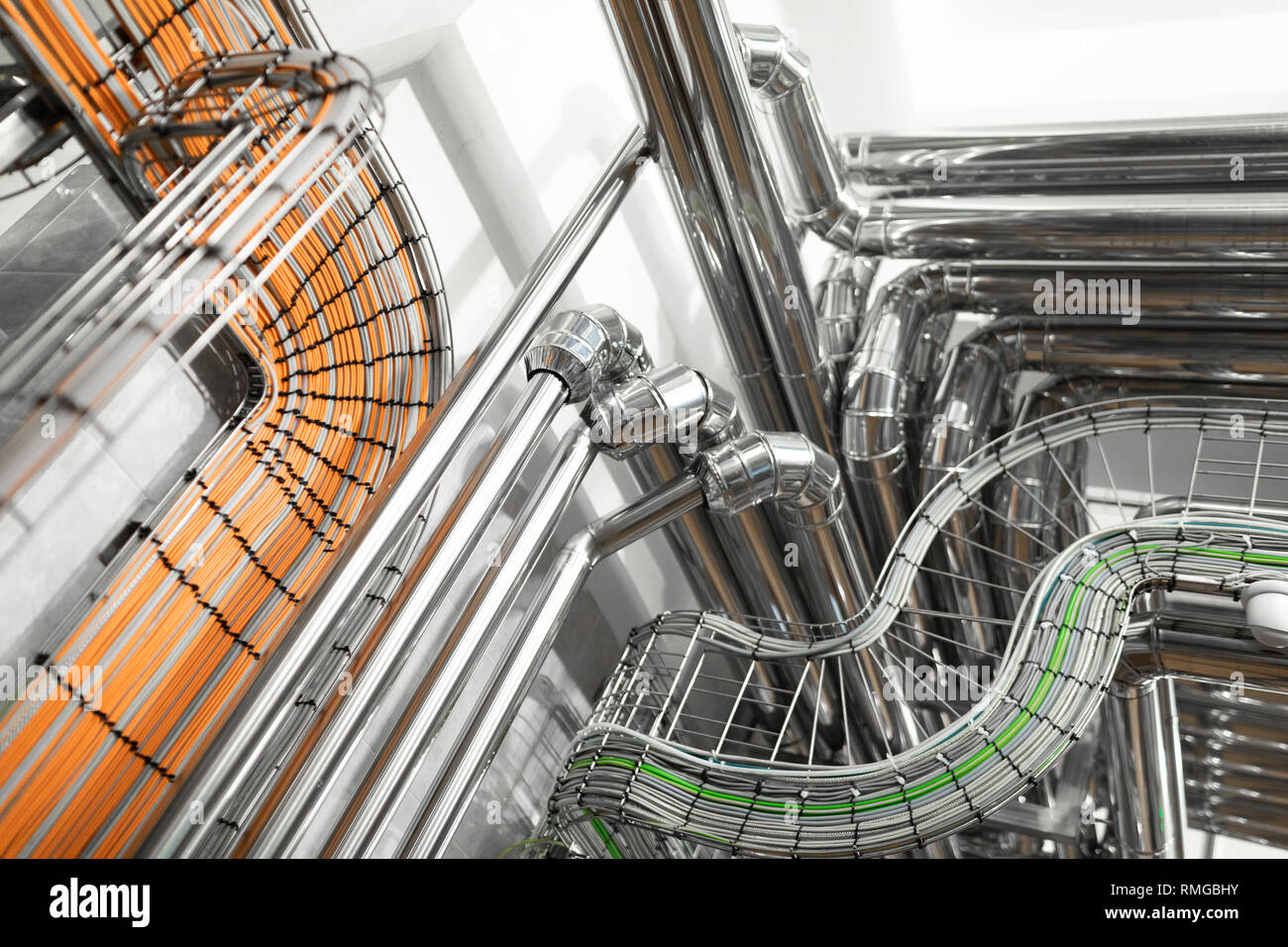 Steel pipelines and cables in factory interior as chemical industry background concept Stock Photo