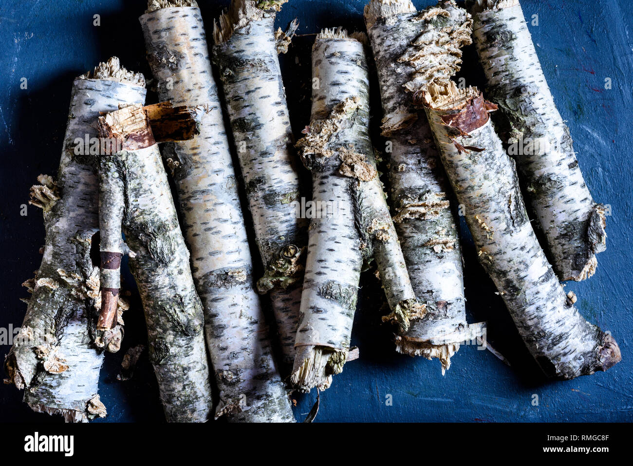 Birch Firewood Logs Stacked On The Blue Background Prepared For