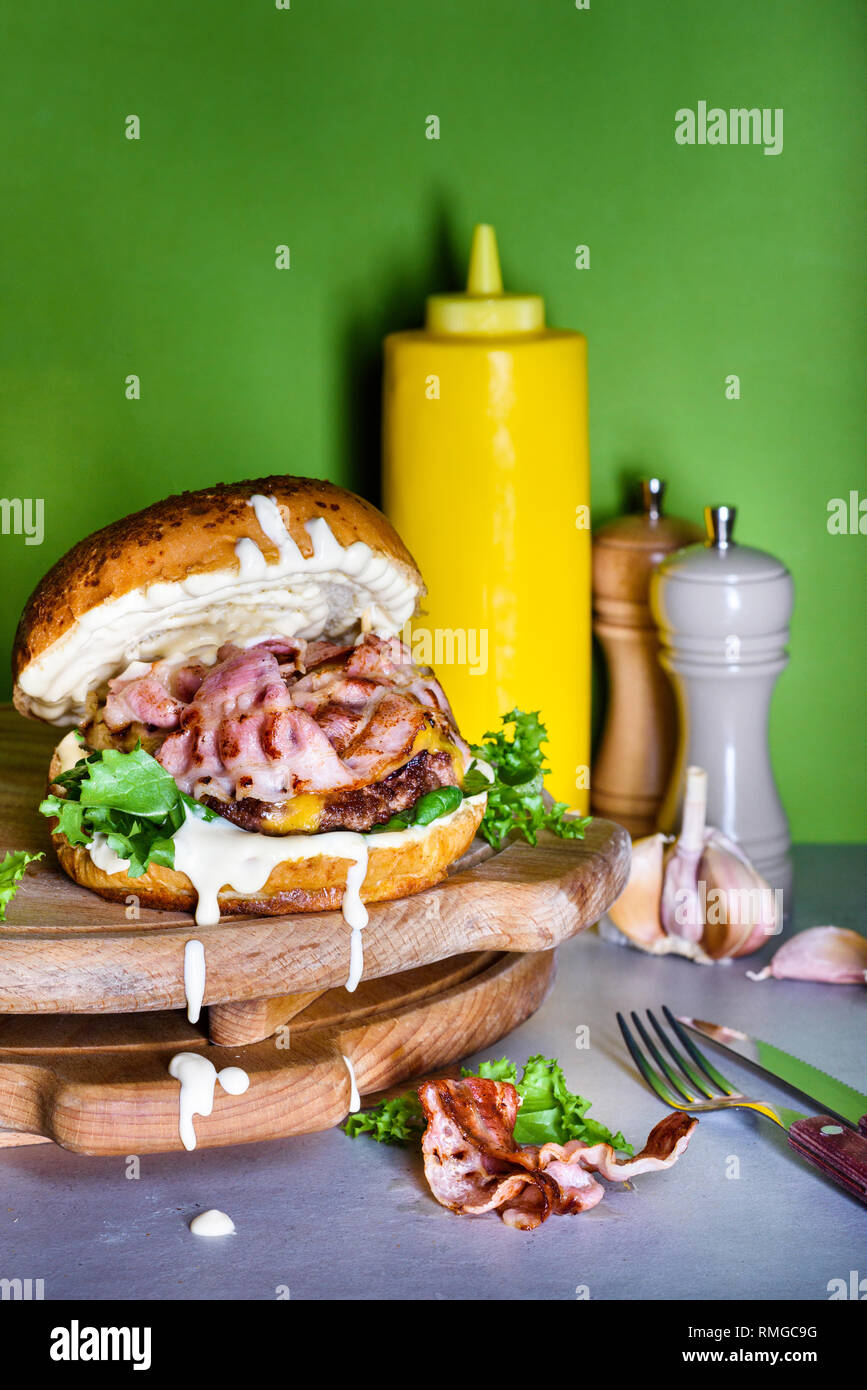 Burger with bacon, mayo and aioli. French fries snack. Hamburger fast