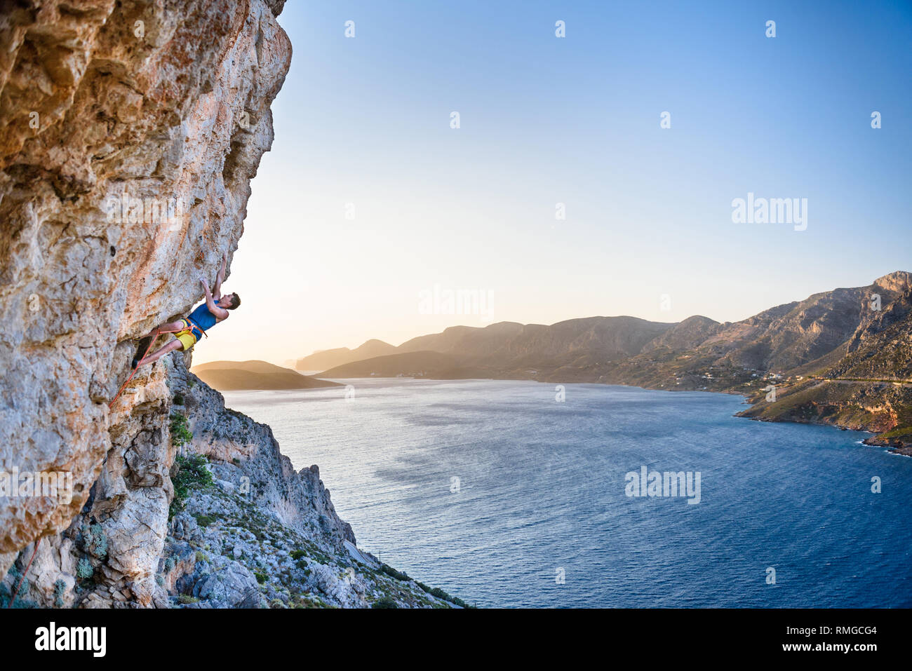 Rock climbing man. Climbing Sport fitness athlete on beautiful rocks