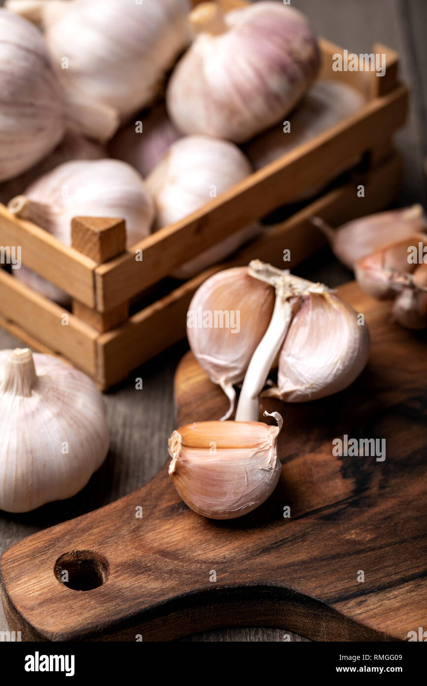 Garlic Cloves and Bulb in vintage wooden bowl Stock Photo - Alamy