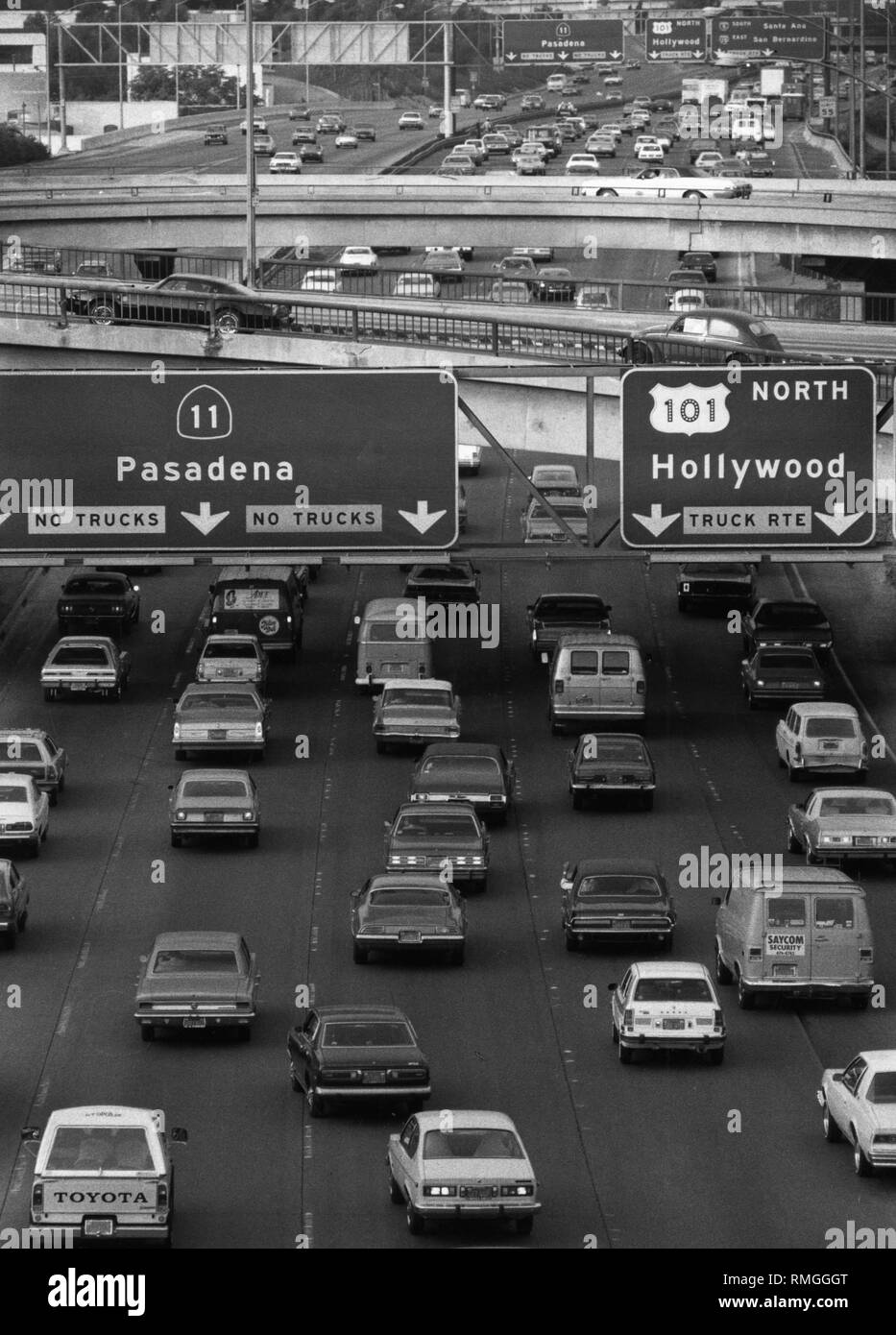 Cars on a street in Los Angeles with signposts to Pasadena and Hollywood. Stock Photo