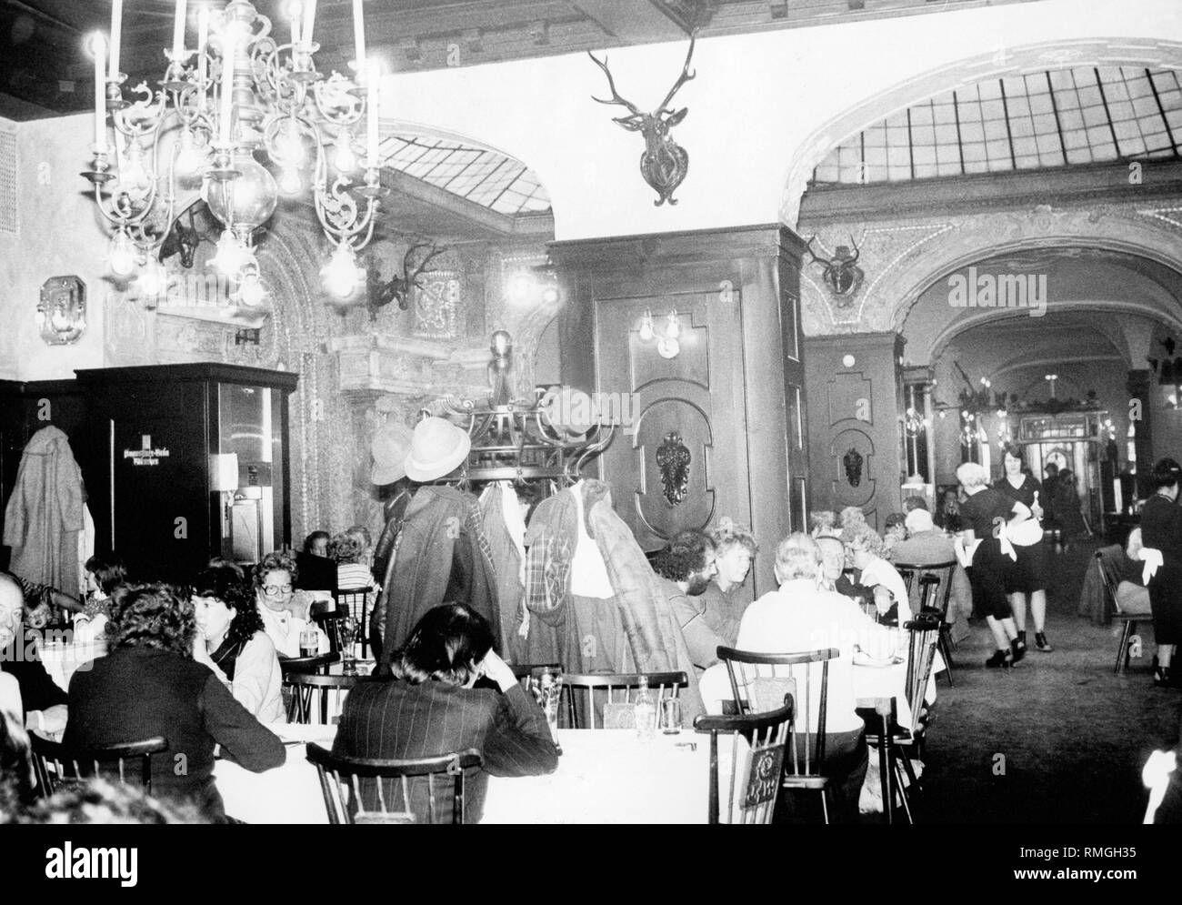 The 'Bierhalle' in the restaurant 'Zum Augustiner' in the Neuhauserstrasse in Munich. In the background the 'Muschenlsaal' with glass dome. The picture shows the restaurant after the renovation. The wooden ceilings, the glass dome and the vault were preserved. Stock Photo