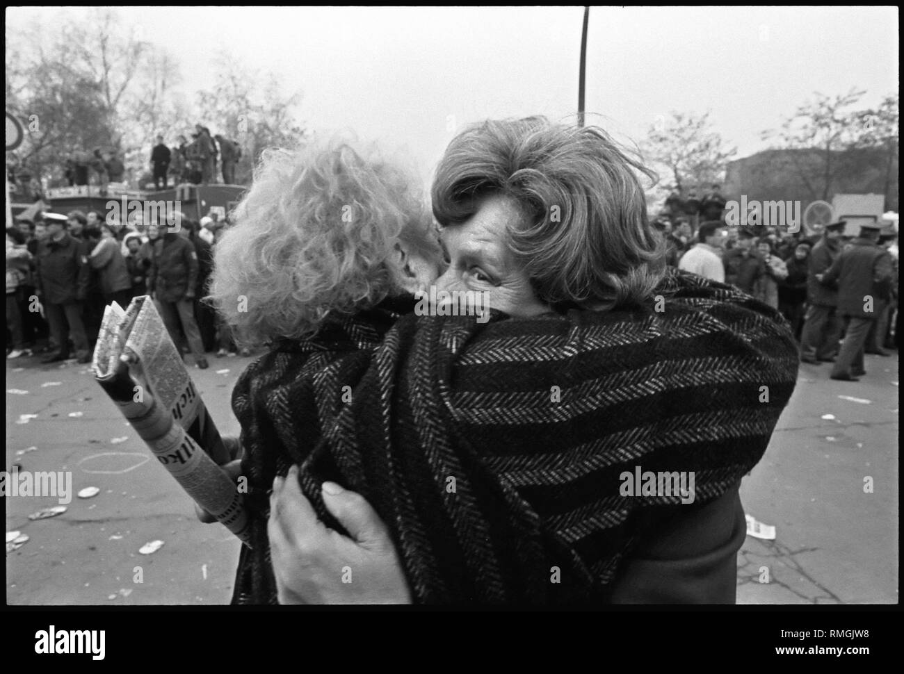 Opening of the Berlin Wall at Potsdamer Platz. Two Berlin women fall ...