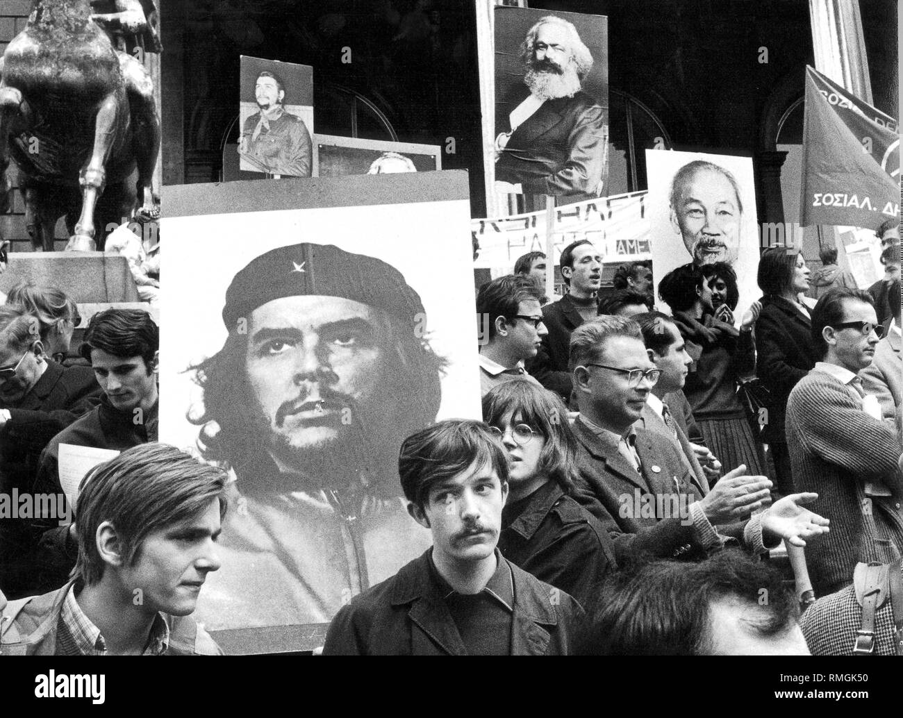 Students are demonstrating in Munich in front of the Feldherrenhalle. They carry banners with portraits of Che Guevara, Ho Chi Minh and Karl Marx with them. Stock Photo