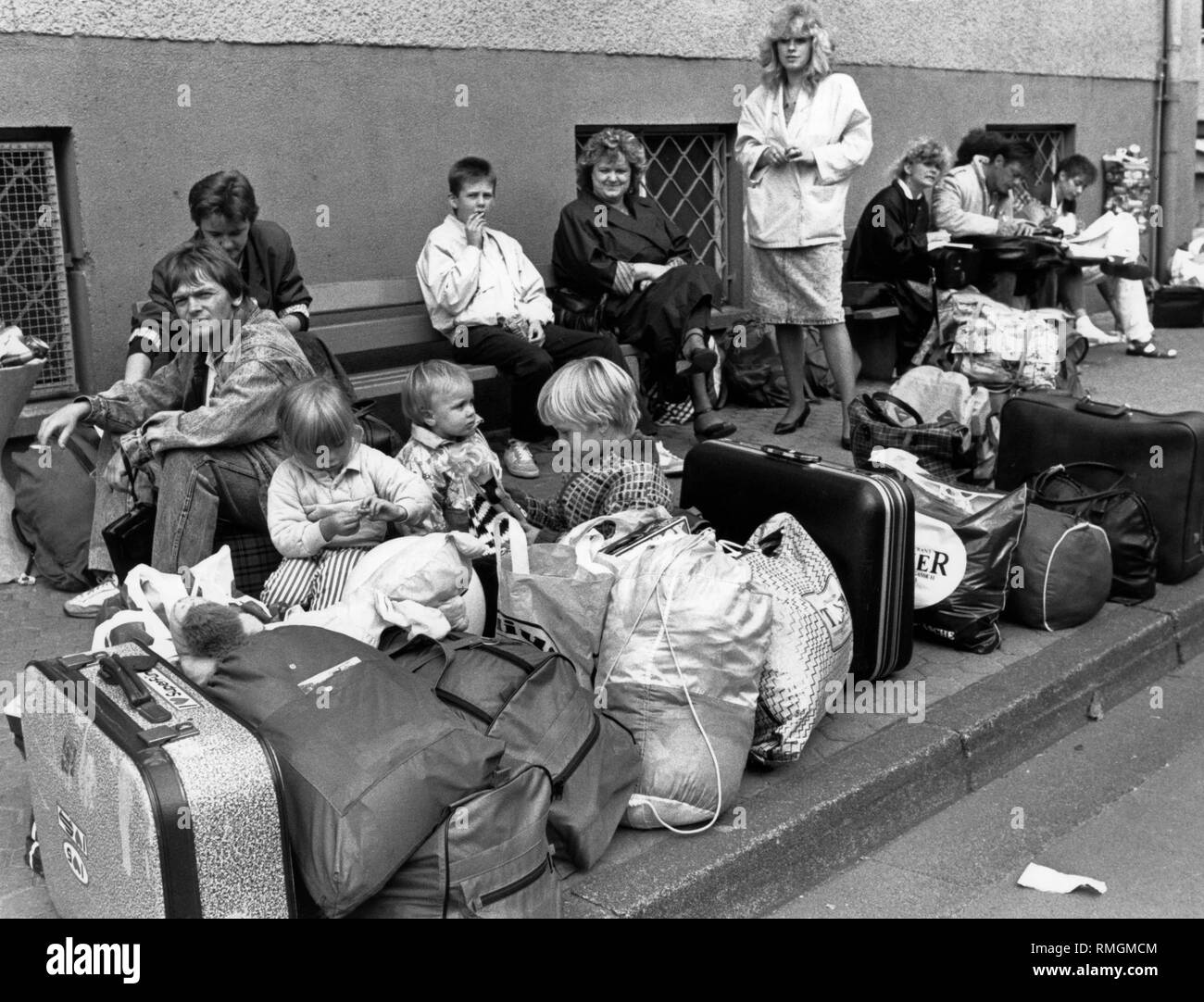 Refugees from the GDR in front of the Federal Reception Center in Giessen, where they are to be registered and receive their admission certificates. Stock Photo