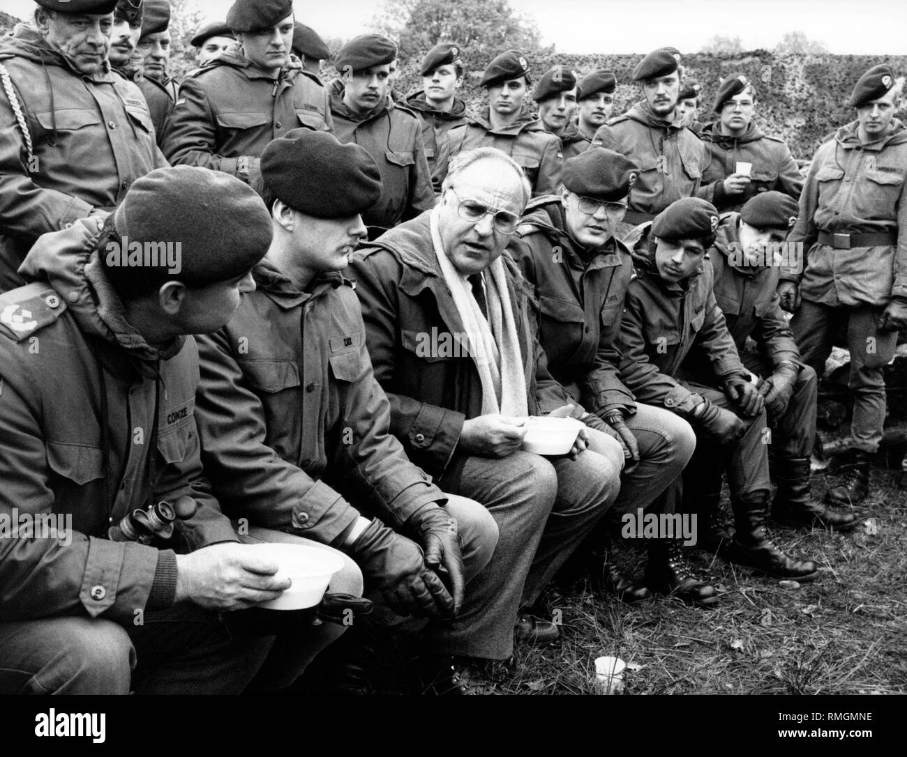 German Chancellor Helmut Kohl (middle) is talking with young soldiers
