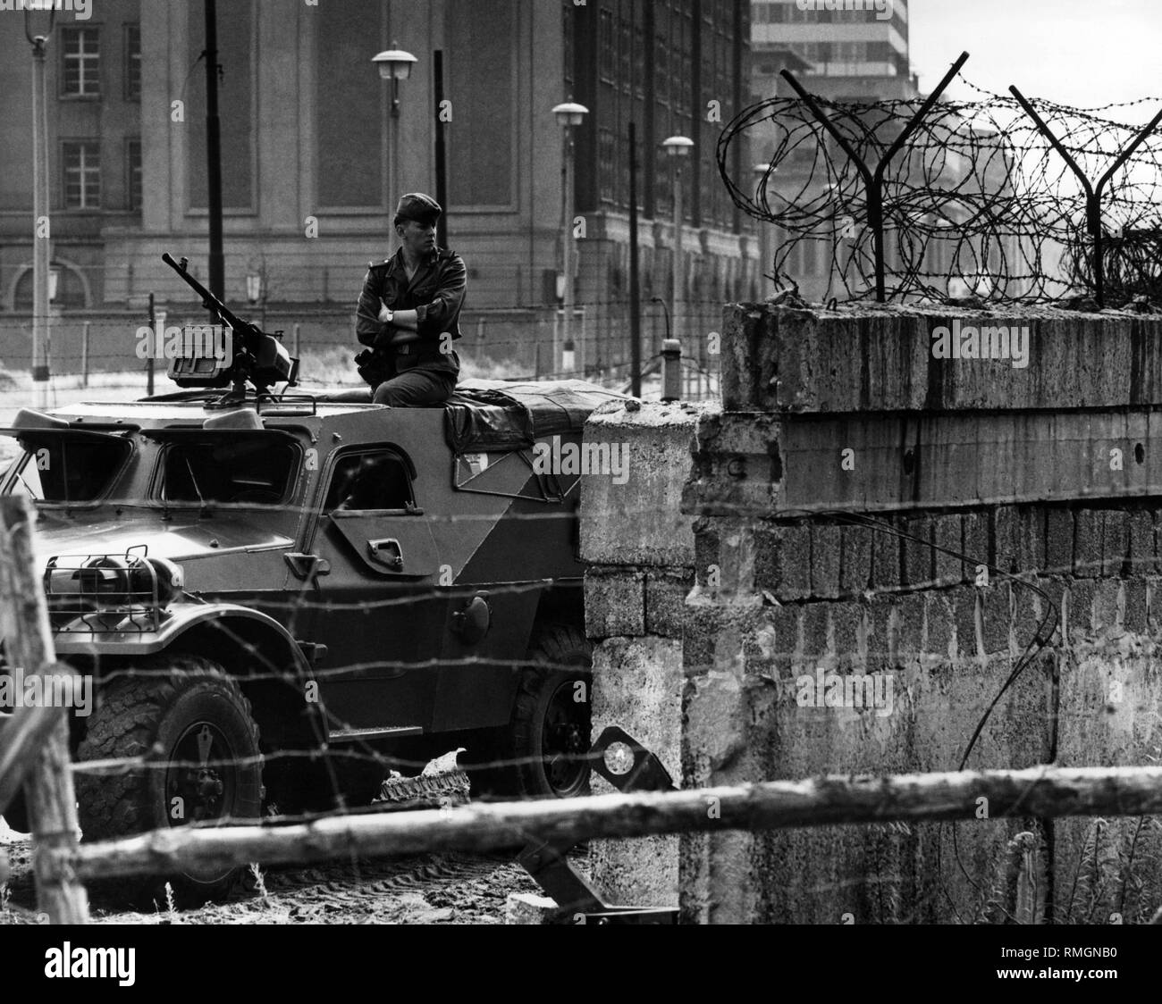 Undated image of a Volkspolizist in an armed and armored vehicle on a section of the Wall at Potsdamer Platz. Stock Photo