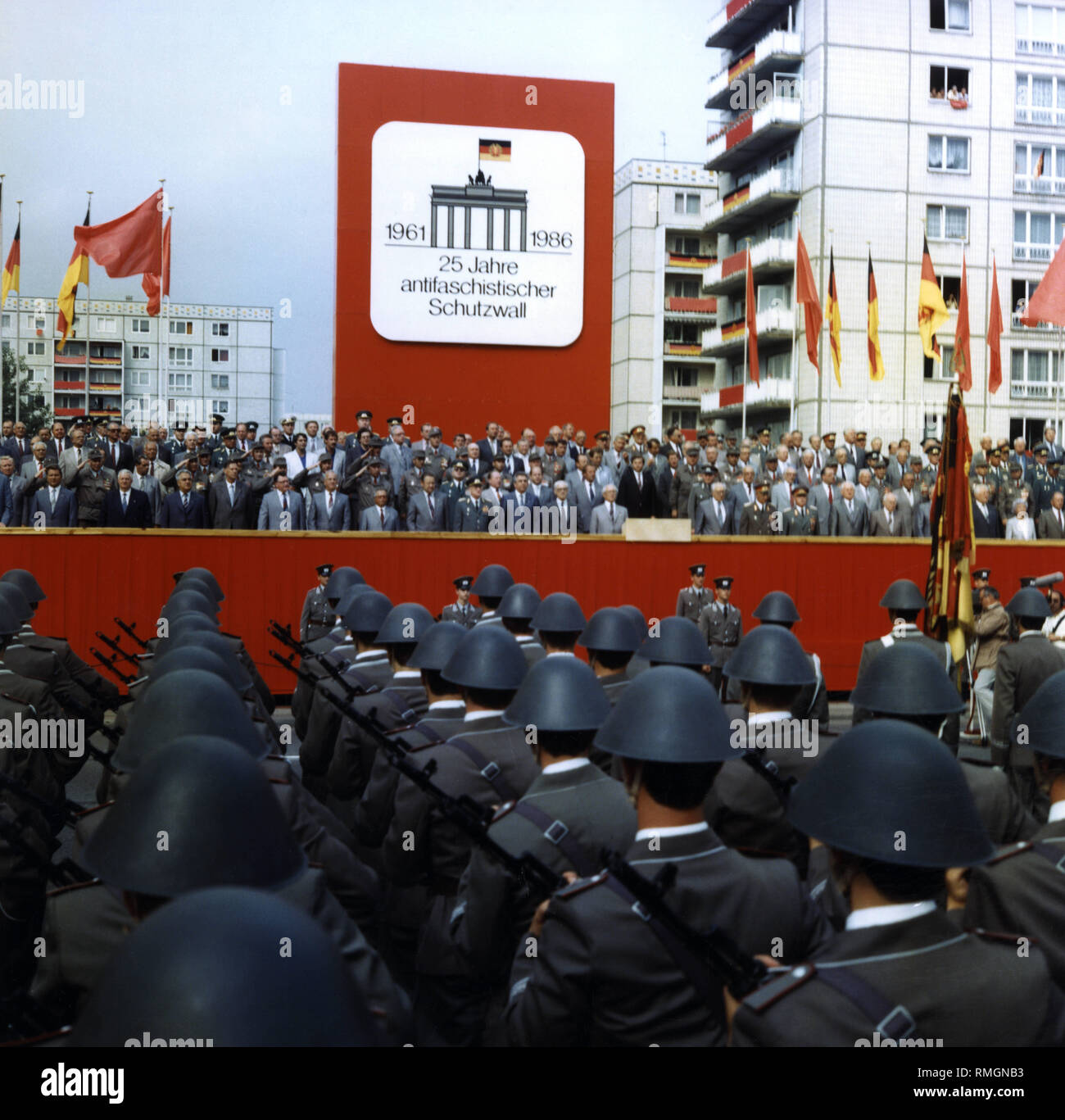 The VIP stand at the celebrations of the "25 years of the Berlin Wall". In the first row, the members of the SED Politburo, including Erich Honecker (on the left next to the lectern). In the foreground, soldiers of the NVA as part of a military parade. Stock Photo