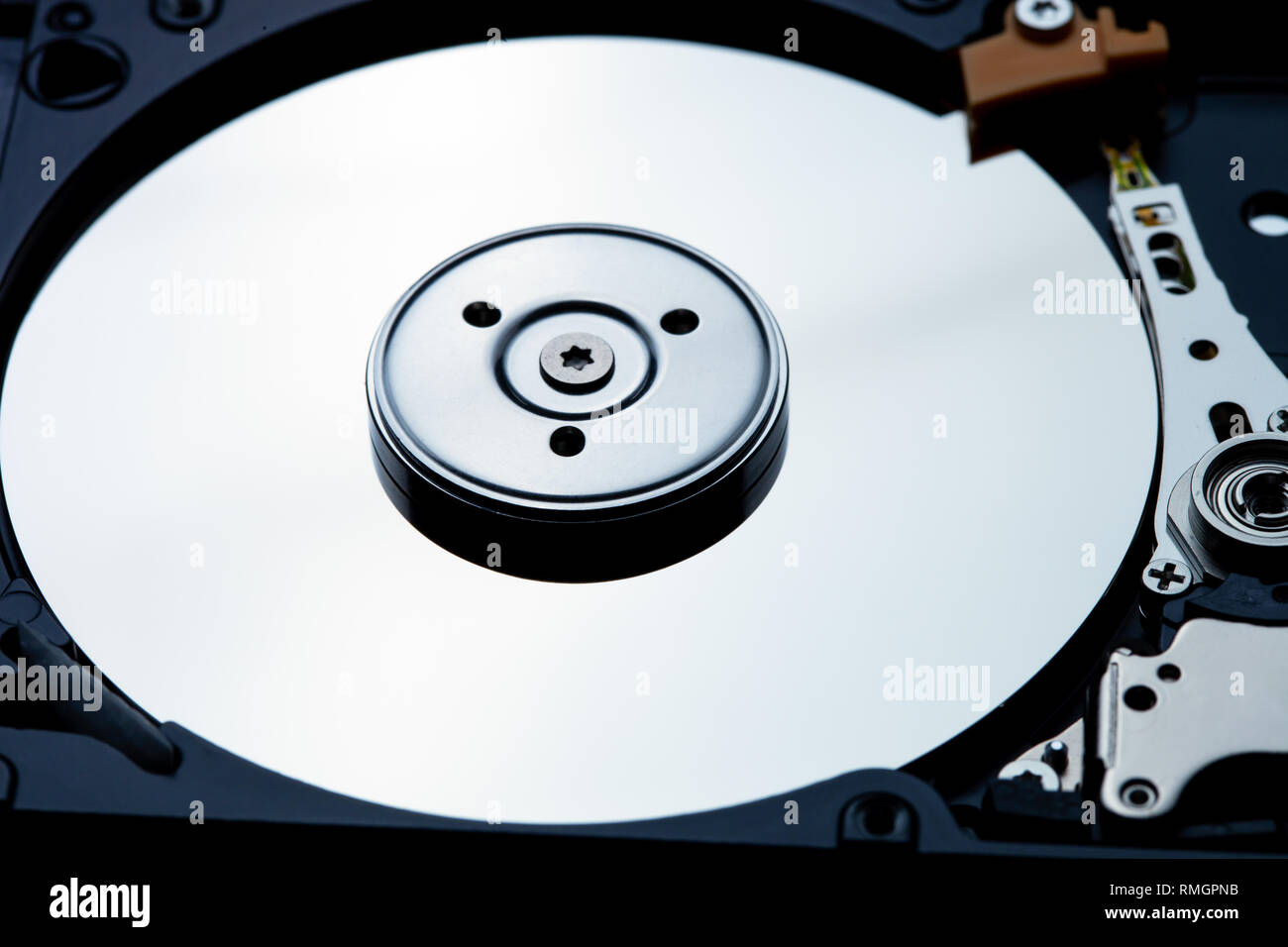 Close up shot of hard disk drive interior showing the metallic shine of the disk Stock Photo