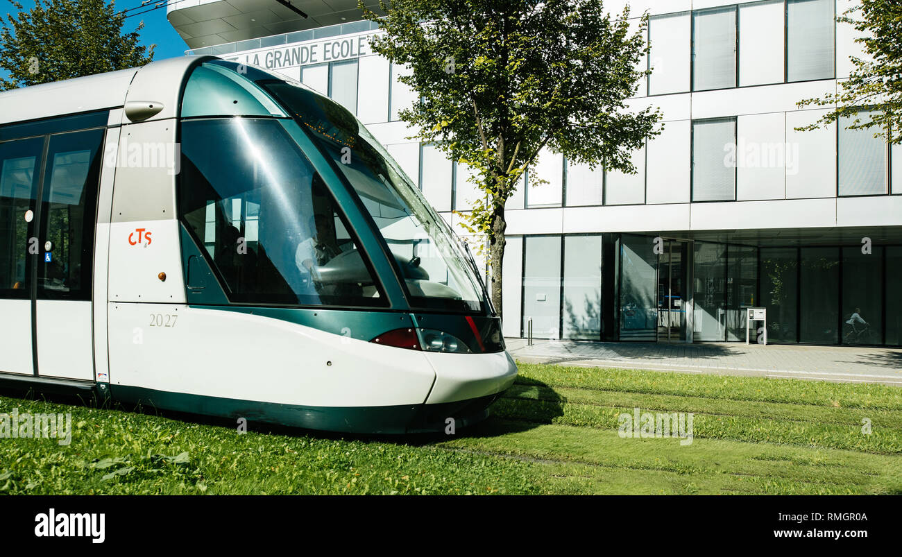 STRASBOURG, FRANCE - SEP 15, 2018: French tramway driving near the Institut national des etudes territoriales INET city public transportation in modern city - tilt-shift lens Stock Photo