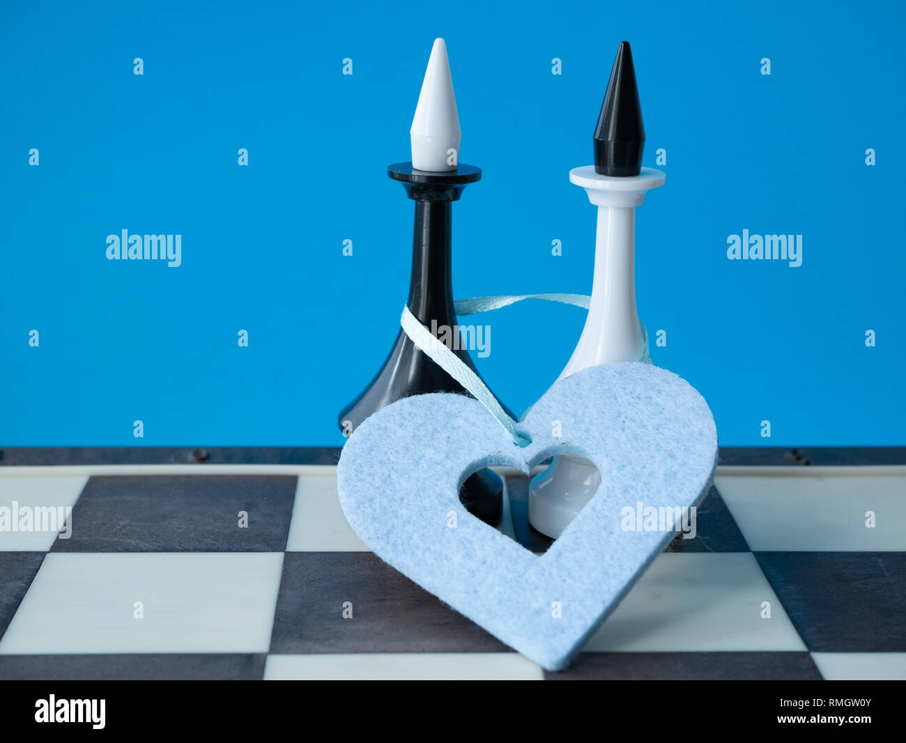 gay marriage wedding invitation concept. two chessman kings with blue heart around Stock Photo