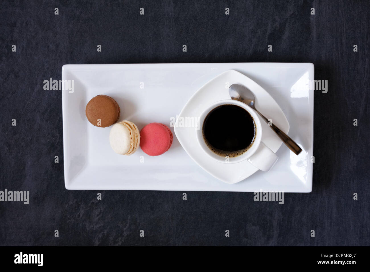 Cup of coffee and three macarons. Stock Photo