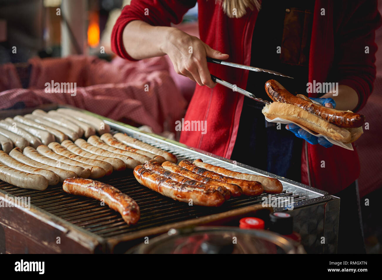 German bratwurst sausages cooked on a grill in a local farmer market. Landscape format. Stock Photo