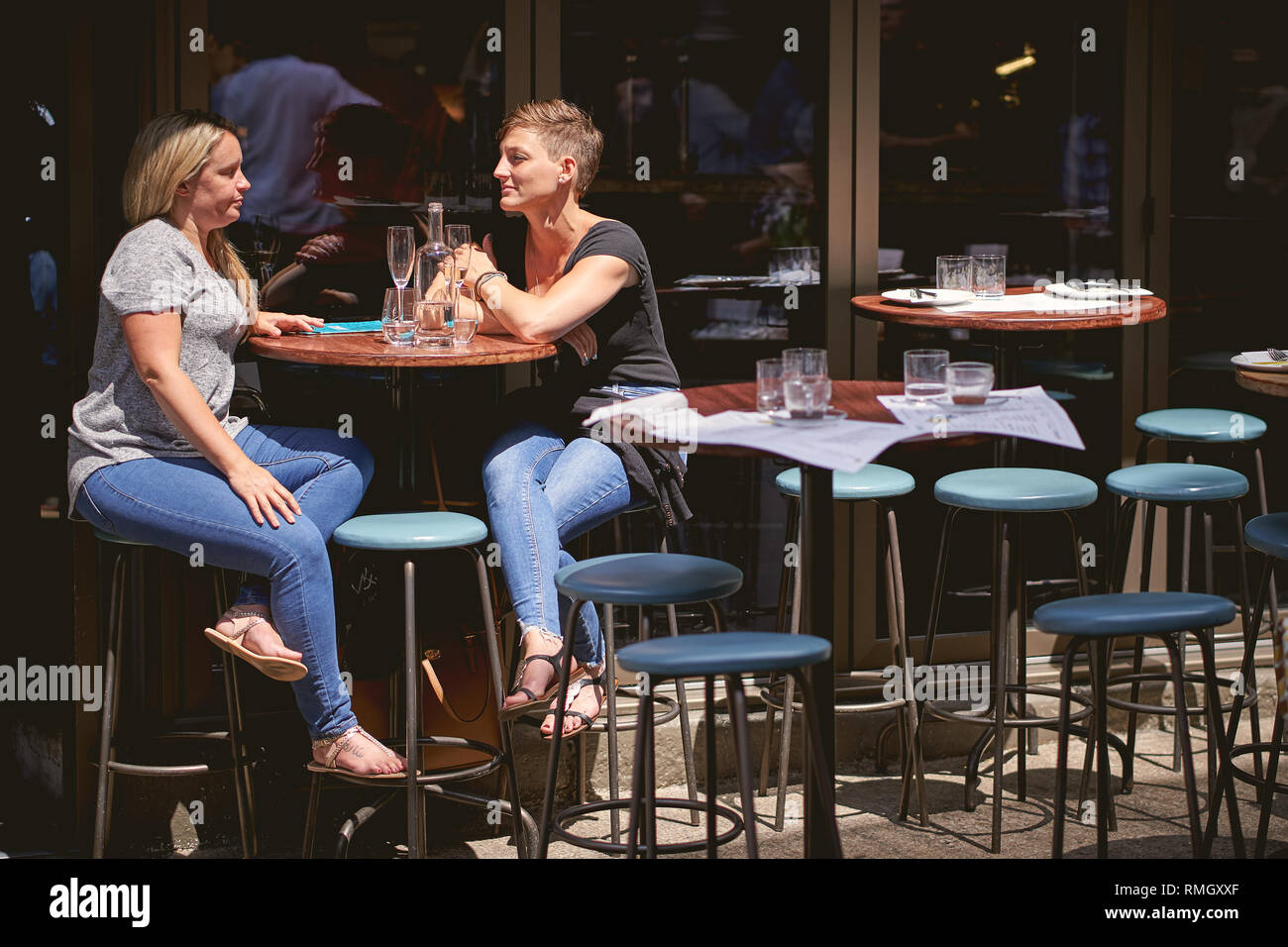London, UK June, 2018. Young people enjoying drinks outside a pub