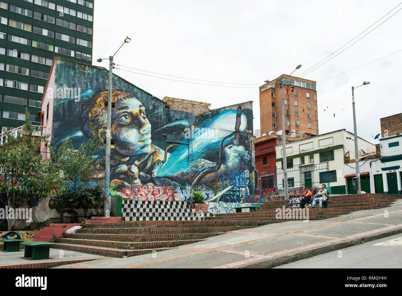 Colourful mural with various types of residential buildings near Parque de Los Periodistas, Carrera 2. Bogota, Colombia. Graffiti credit: Bastardilla Stock Photo