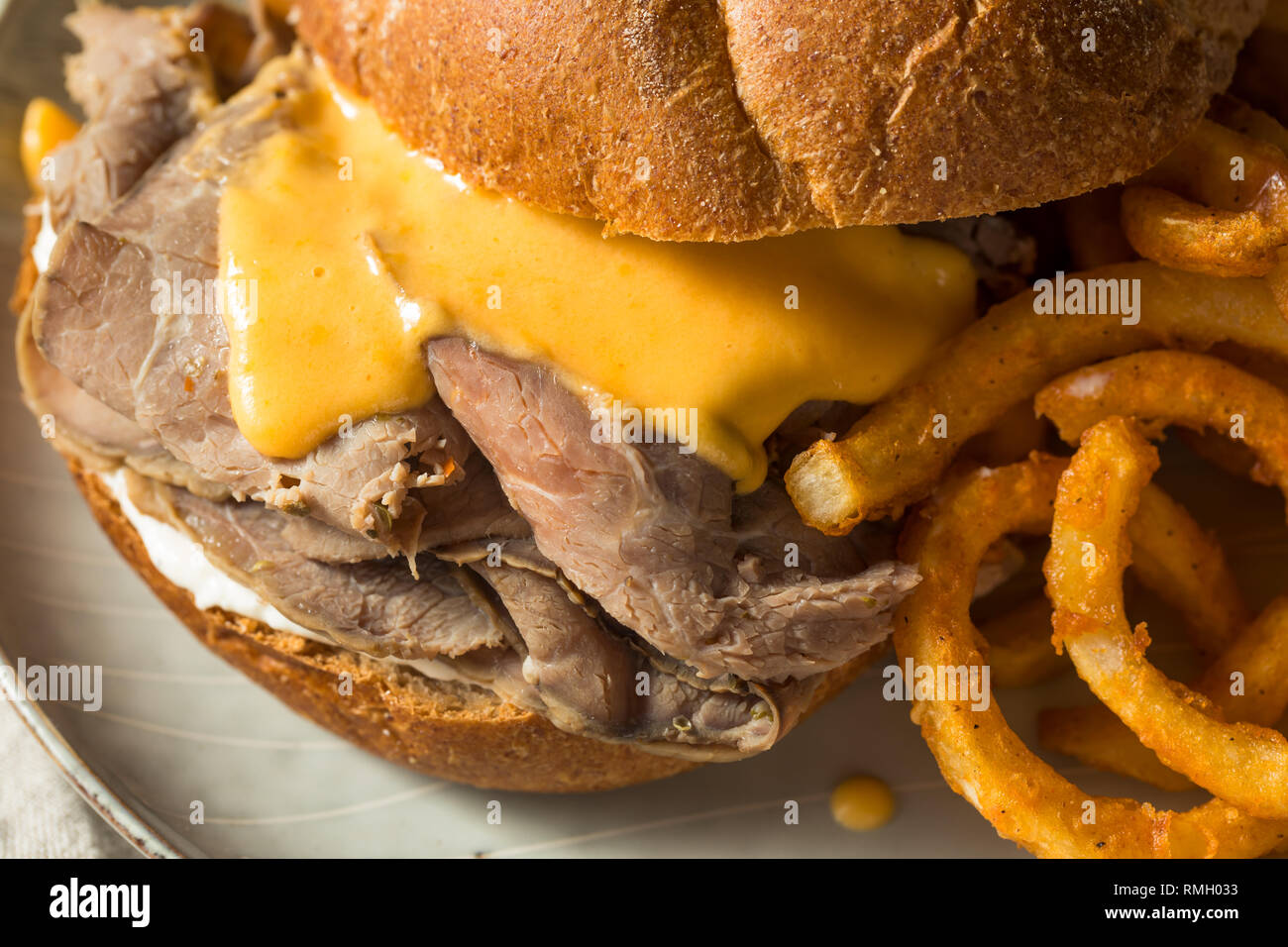 Homemade Roast Beef and Cheddar Sandwich with Curly Fries Stock Photo