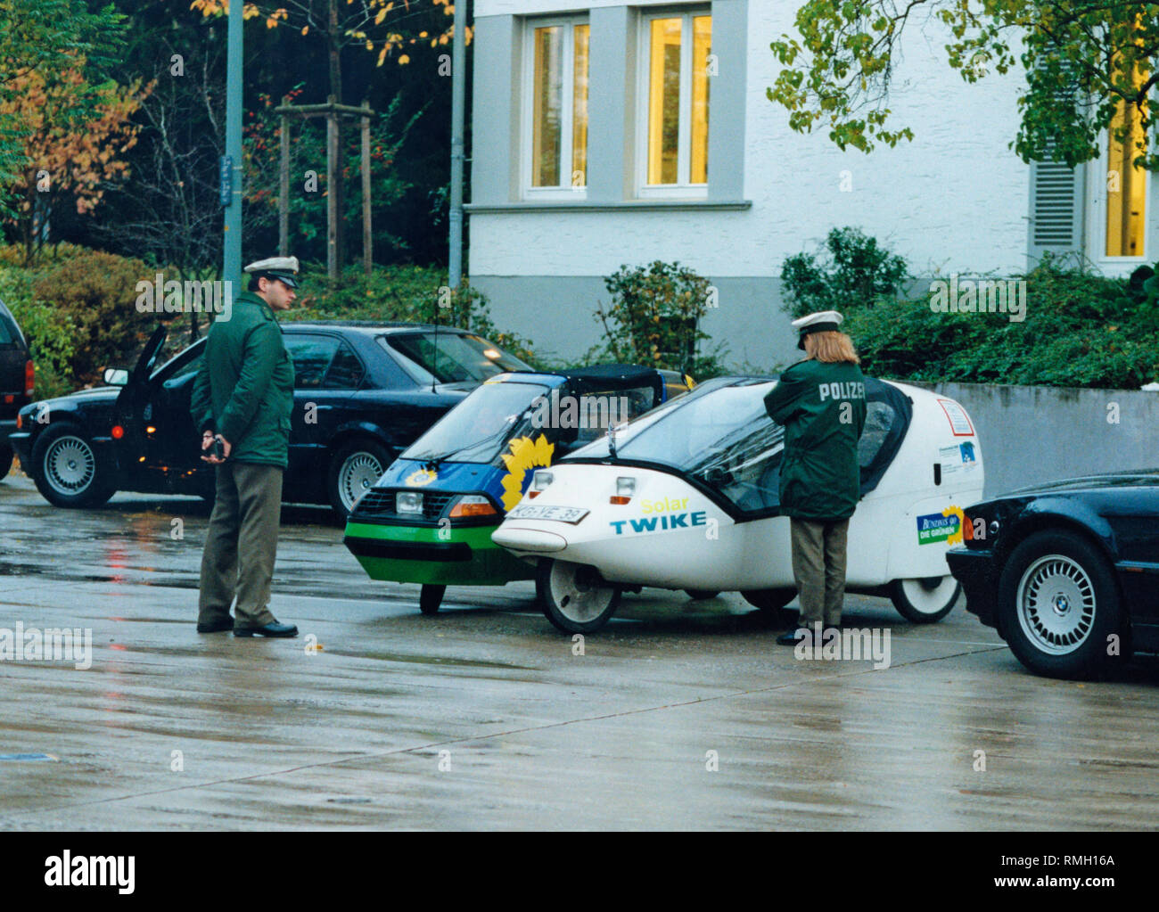 Policemen look at the electric tricycles of the Green faction in the