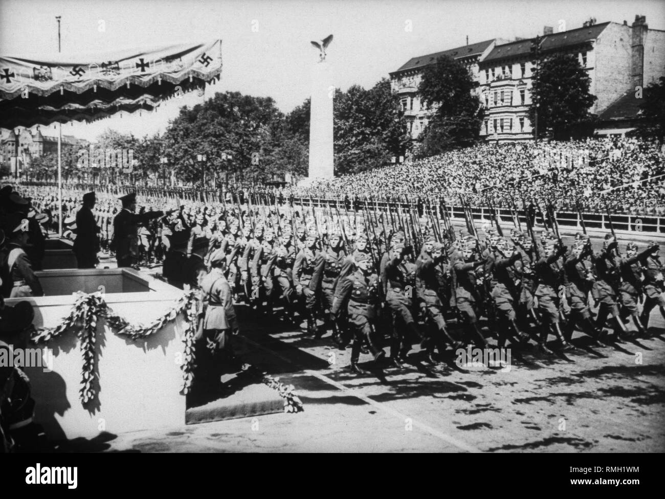 Adolf Hitler during the march of the German units of the Condor Legion that has returned from Spain in front of the Technische Hochschule. Next to Hitler, the last commander of the Legion, Major General Wolfram Freiherr von Richthofen. Stock Photo