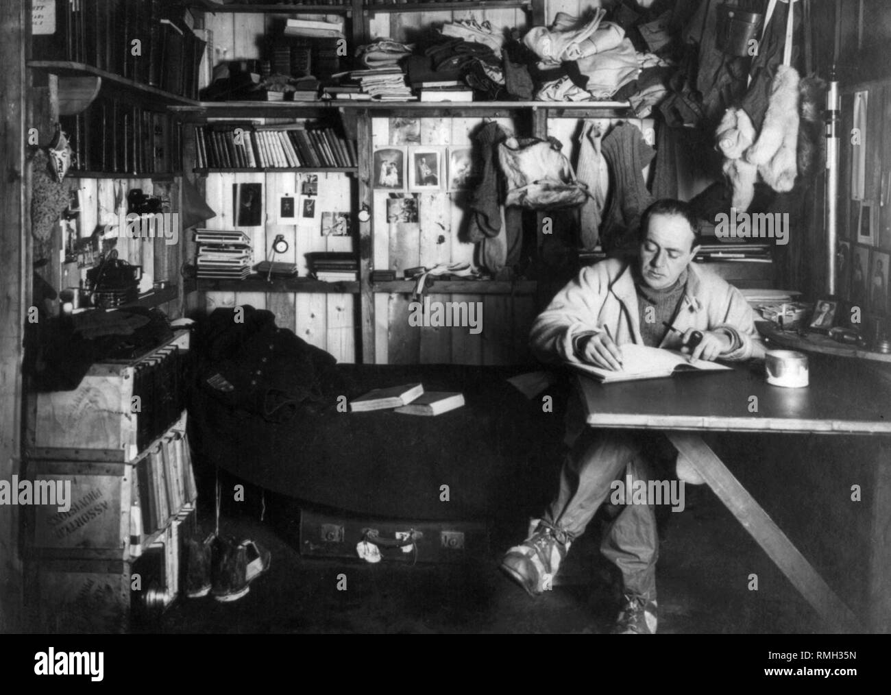 Captain robert D scott writing in his diary in his quarters leader of the Terra Nova expedition during the British Antarctic Expedition to Antarctica  Photo taken 1910 Stock Photo