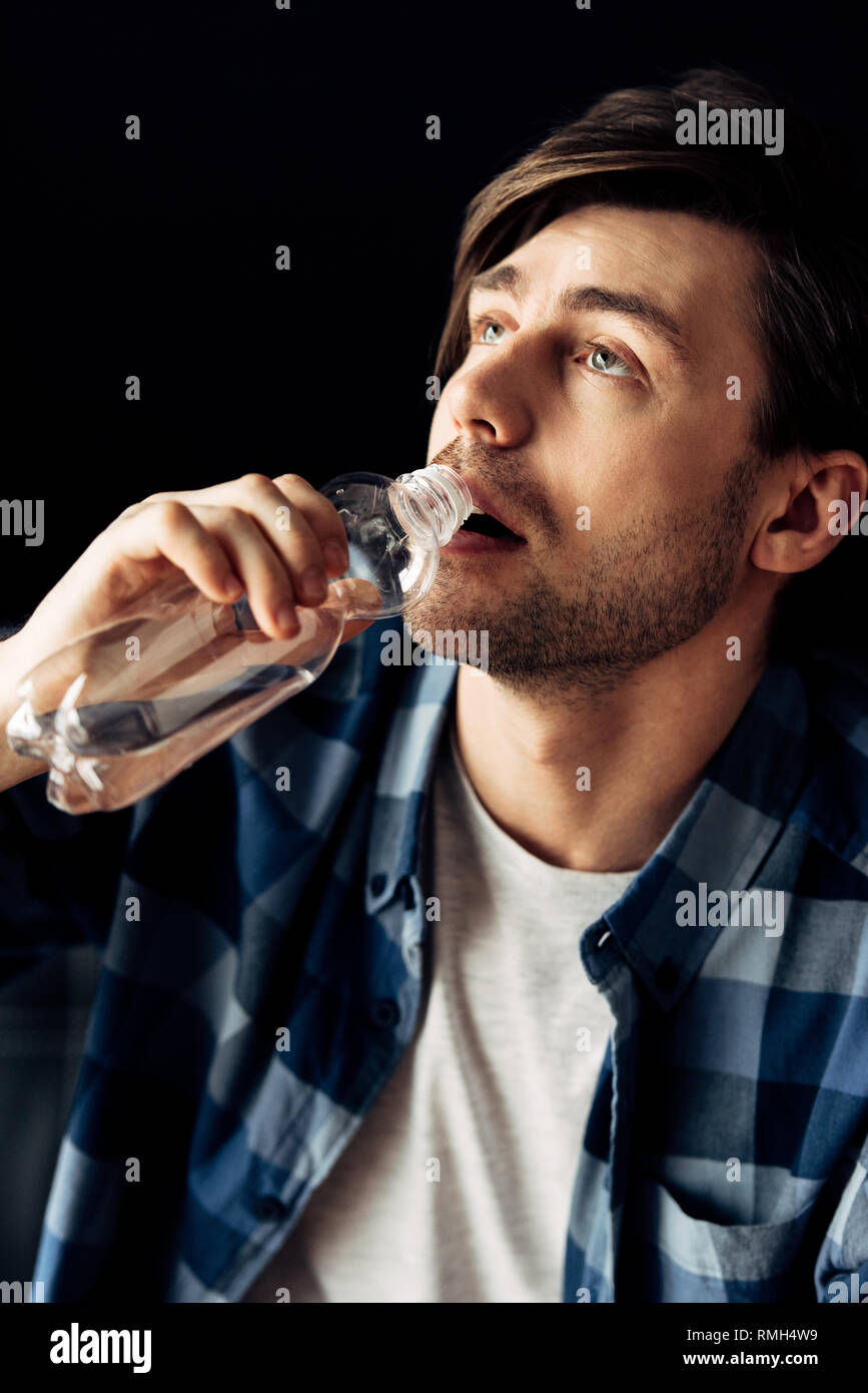 man suffering from hangover drinking water after party Stock Photo Alamy