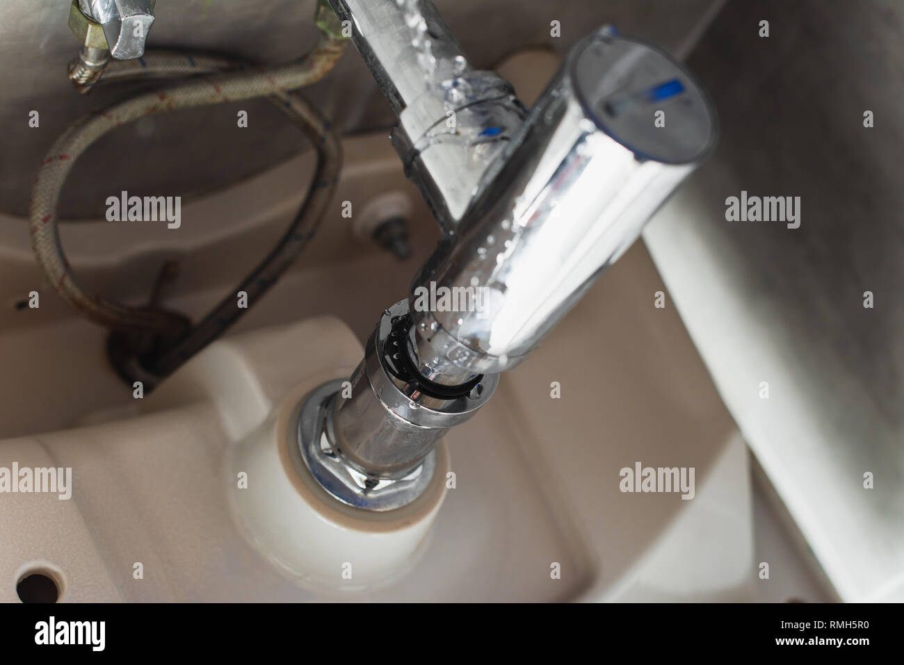 Leaking steel pipes under sink with water drops Stock Photo Alamy