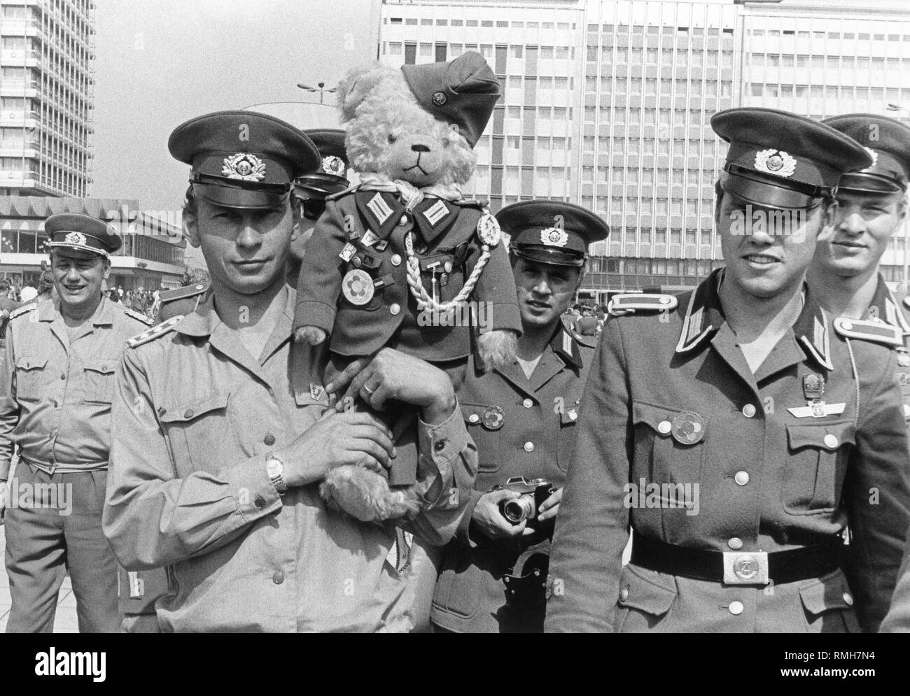 Soldiers of the GDR People's Army with a teddy bear as a mascot in army uniform during the World Festival from 28 July to 5 August 1973 on the Alexanderplatz in Berlin Stock Photo