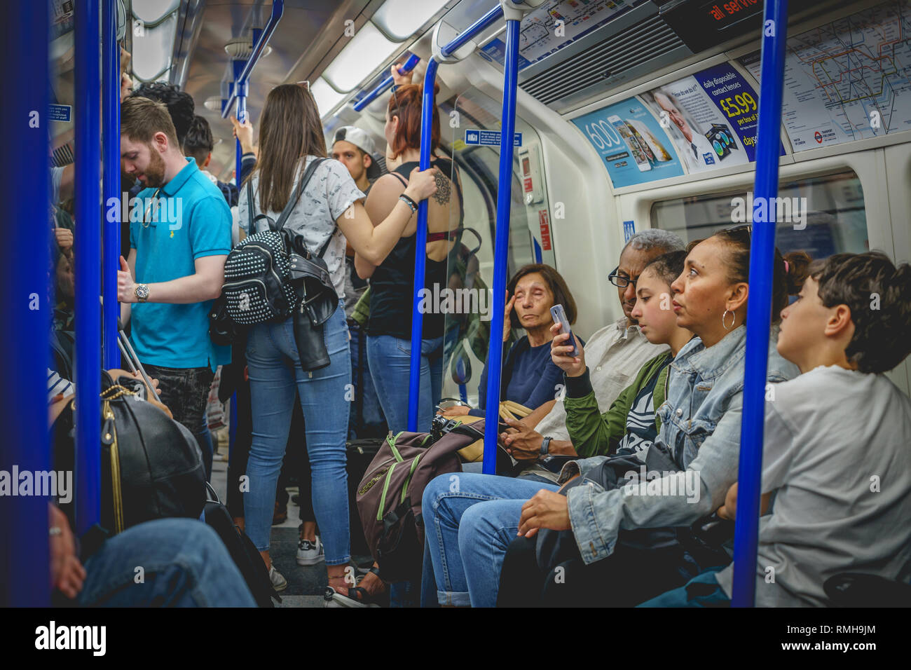 London, UK - April, 2018. People commuting on an underground train in London. The Tube handles up to 5 Million passenger per day. Stock Photo