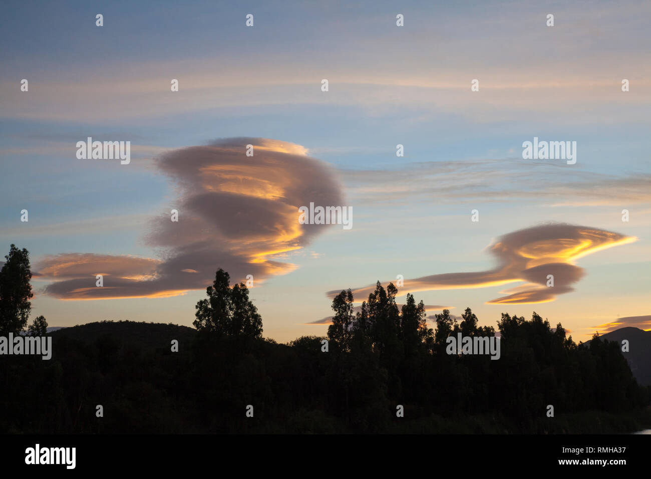 Lenticular clouds at sunset, Breede River Valley, Robertson, Western Cape, Hogh altitude lens-shaped stationary clouds, atmospheric waves, wind, turbu Stock Photo