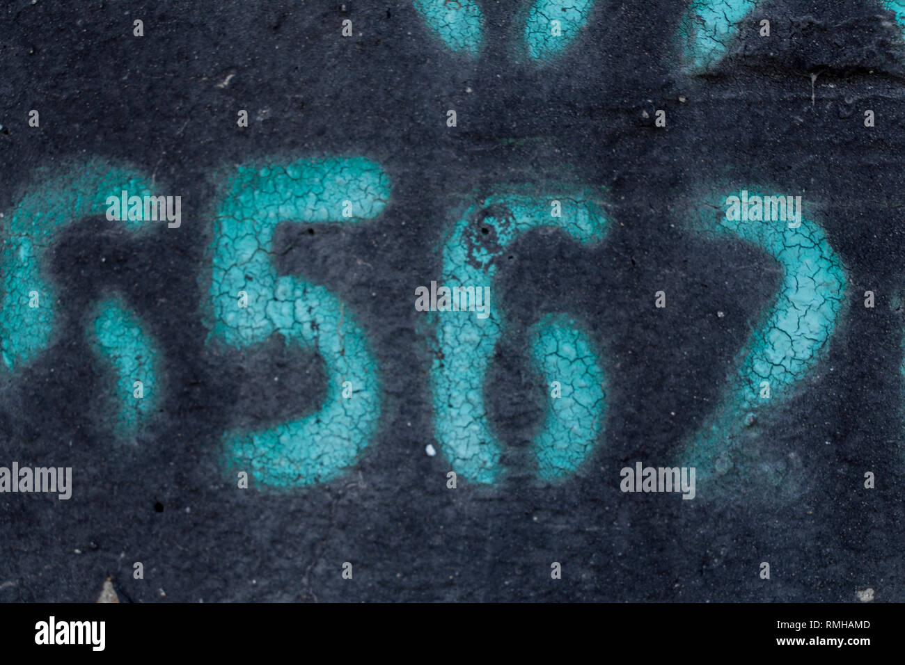 painted number on blak backdrop, stencil number in spray paint Stock