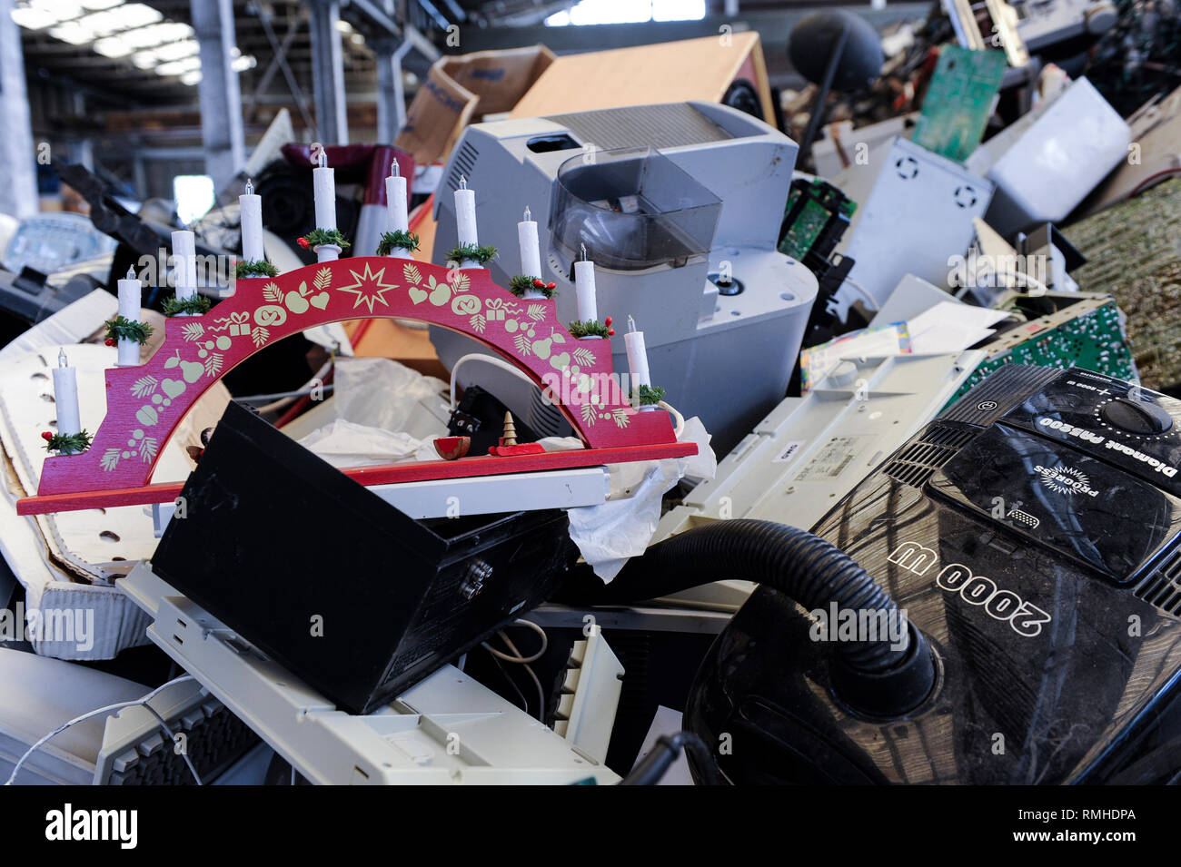 GERMANY, Hamburg, recycling of electronical scrap and old consumer goods at company TCMG, the trash is collected by the urban waste disposal system and than processed and separated here after metals like copper and plastics for further recycling and reuse, by law is not allowed to export e-scrap to africa and other countries, computer keyboards and electric Advent candle Stock Photo