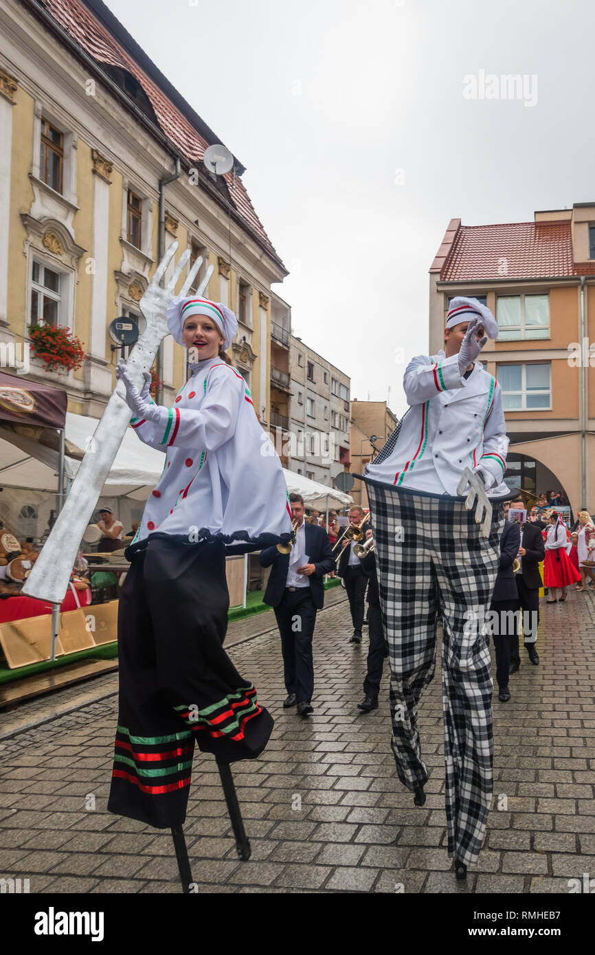 Jawor, Poland - August 2018 : Street circus performers walking on stilts during parade on the annual Bread and Gingerbread Festival Stock Photo