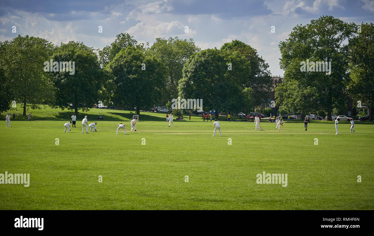 London, UK - February, 2019. People playing cricket in park in South London Stock Photo