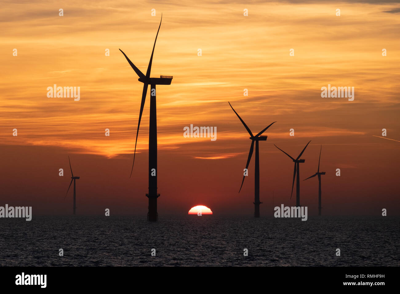 Wind turbines on the London Array Offshore Wind Farm in the Outer Thames Estuary during sunset Stock Photo