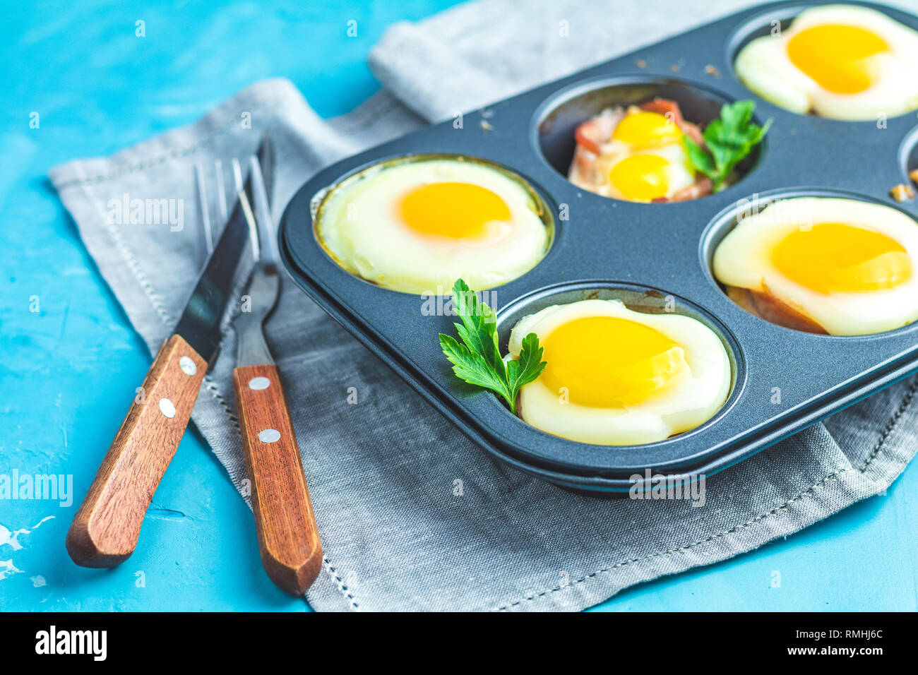 Baked eggs in baking molds. Portioned casserole from bacon sowbelly and