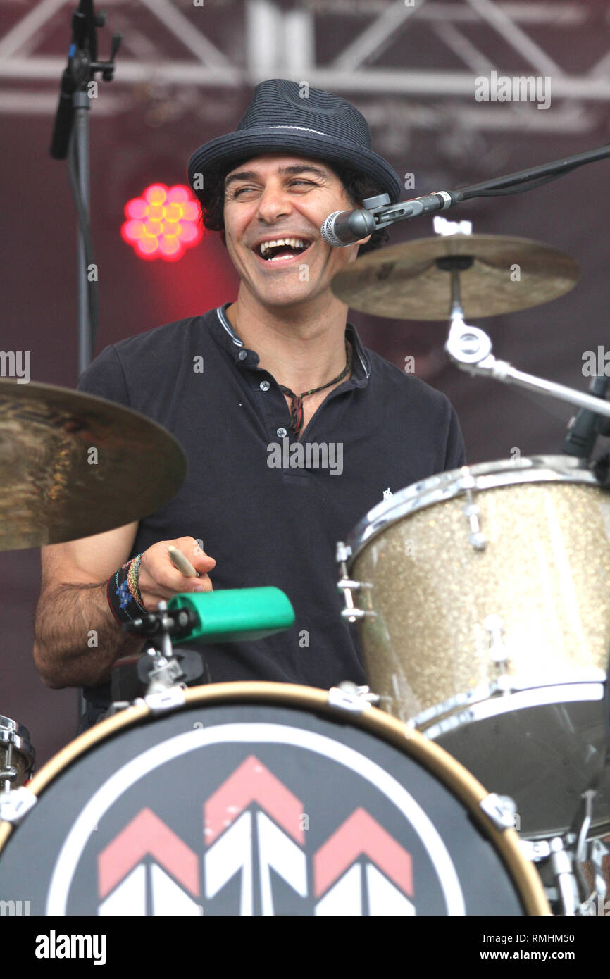Drummer Nicky Bomba is shown performing on stage during a 'live' concert appearance with the John Butler Trio. Stock Photo
