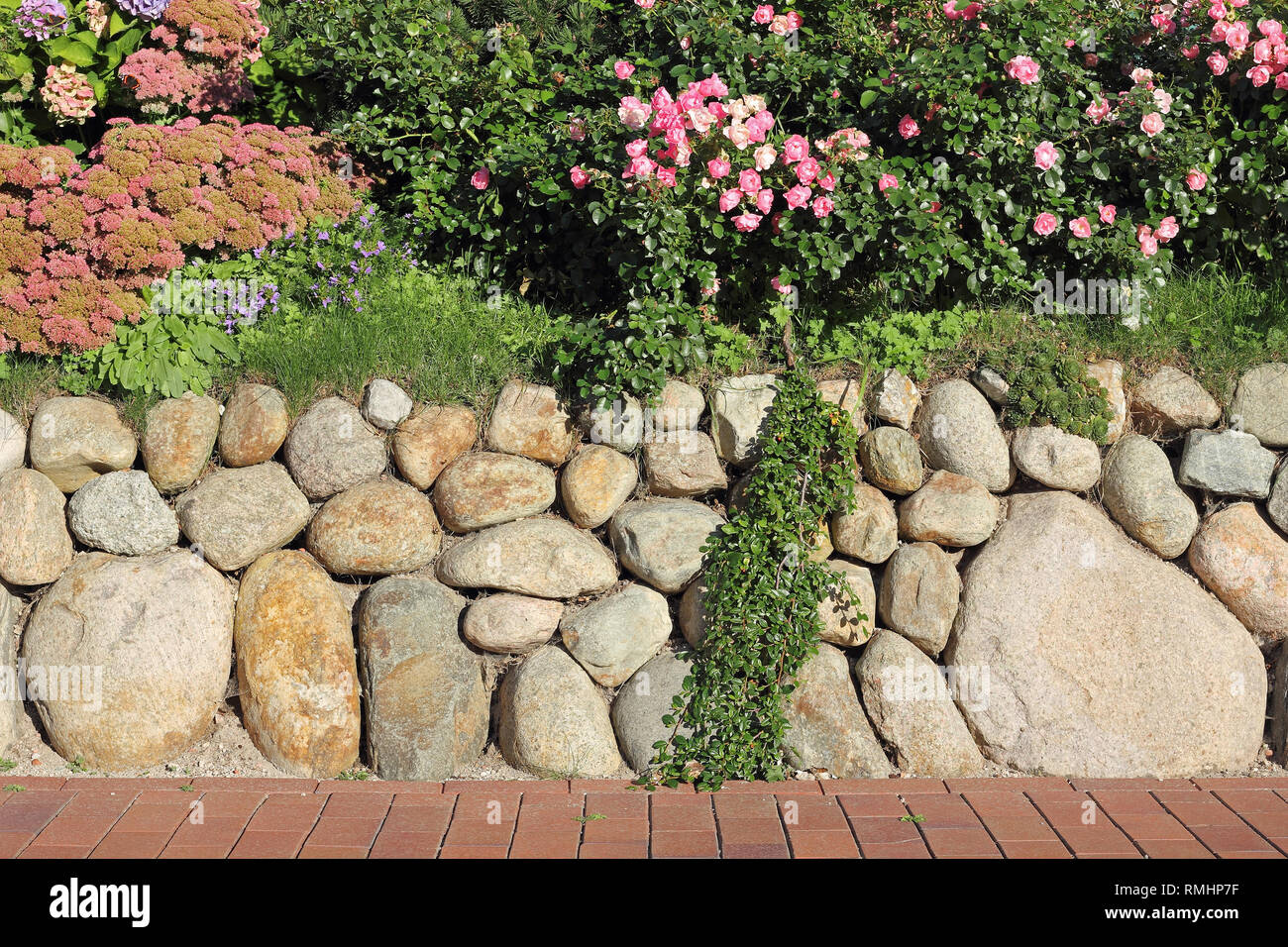 Frisian stone wall planted with flowers Stock Photo